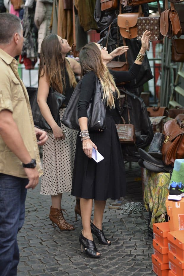 Sarah Jessica Parker with a friend rummaging through the clothing rails at the Via Sannio flea market in Rome
